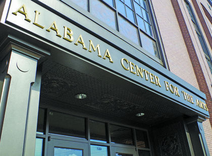 Exterior front entrance of the Alabama Center for the Arts, a large brown brick building.