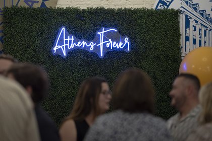 Neon blue sign that reads, "Athens Forever"