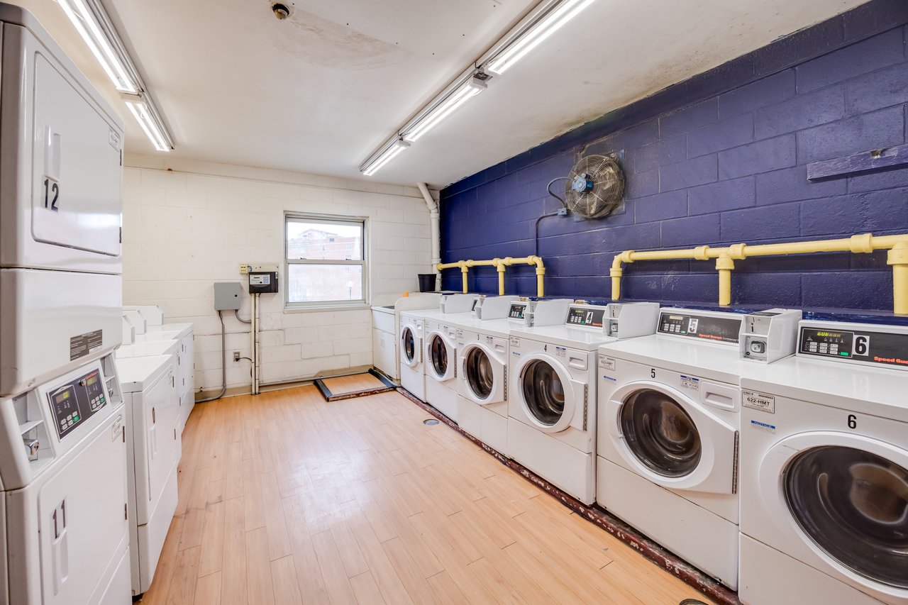 Washers and dryers line the walls in the Davis Apartments Laundry Room.