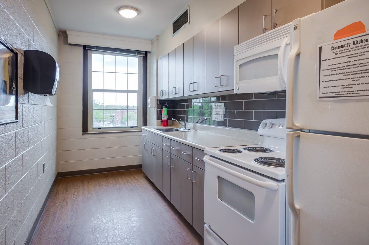 Small kitchen with a stove, fridge, microwave, and sink for students to use in West Hall.
