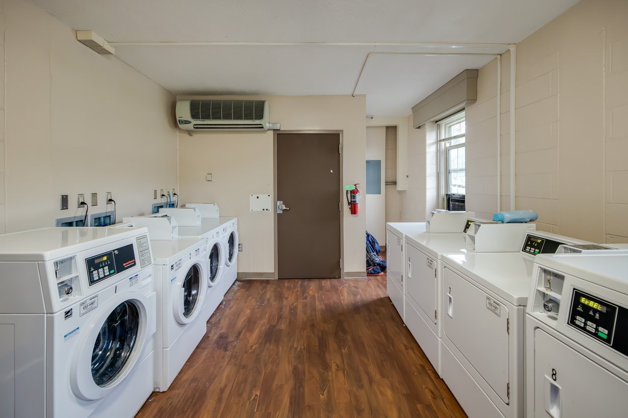 Washers and dryers line the walls of the Dossett Hall laundry room.