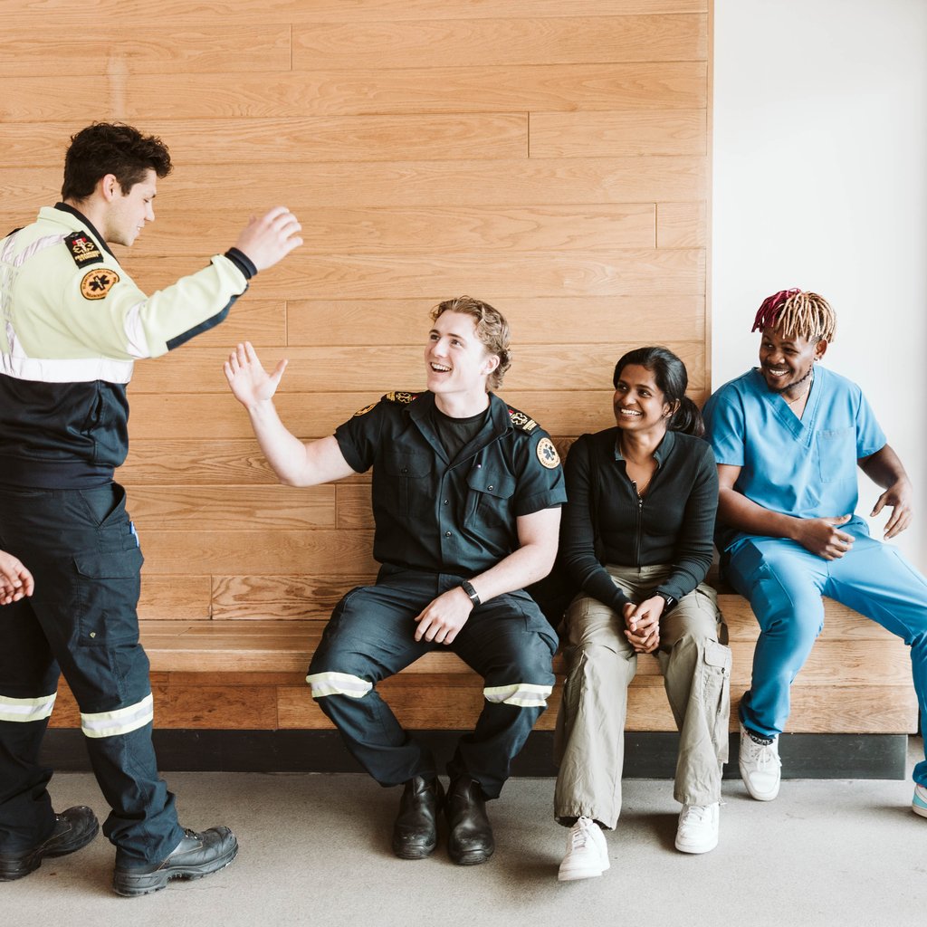 A diverse group of students chatting in the main foyer area